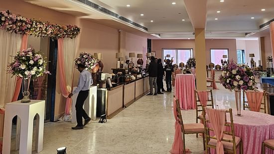 Image of elegantly arranged tables and chairs, ready to host a lavish banquet in the ballroom.